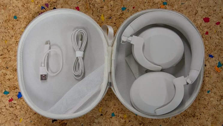 The Philips H8000E over-ear headphones in their carrying case