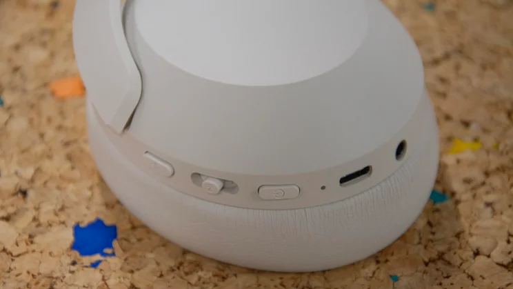 The controls and ports on the right earcup of the Philips H8000E over-ear headphones