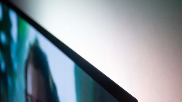 Side view of the Philips OLED760 TV showing how its Ambilight projects light onto the wall behind it
