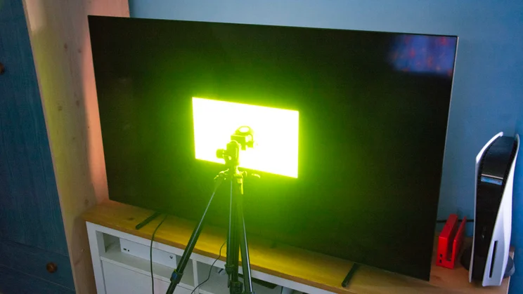 The Philips OLED760 TV with a colour patch displayed on screen and a calibrator against the panel
