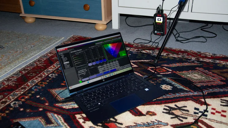 An HP laptop running Calman Ultimate with the pattern generator used to test the Philips OLED760 TV behind it