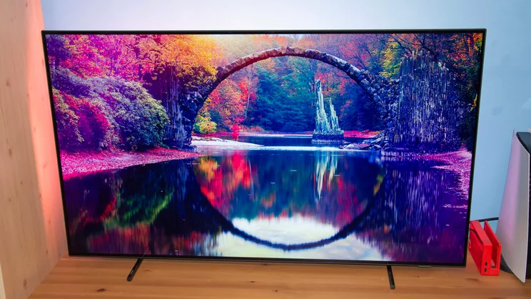 Front view of the Philips OLED760 TV displaying a beautiful lake reflection