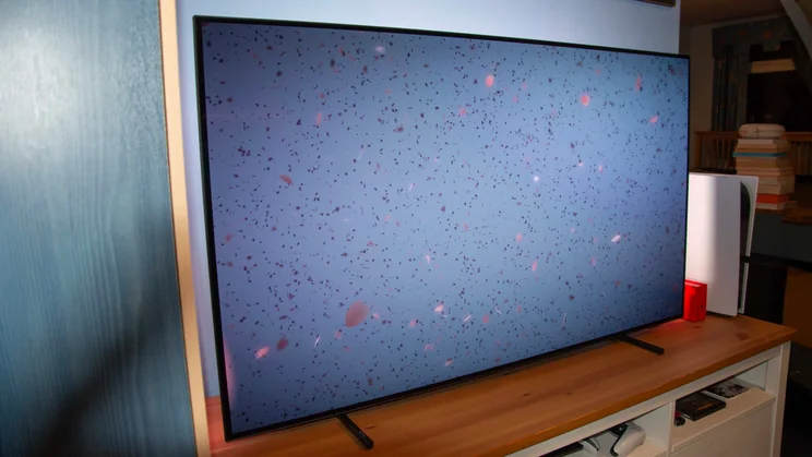 Left view of the Philips OLED760 TV displaying a grey background and confetti