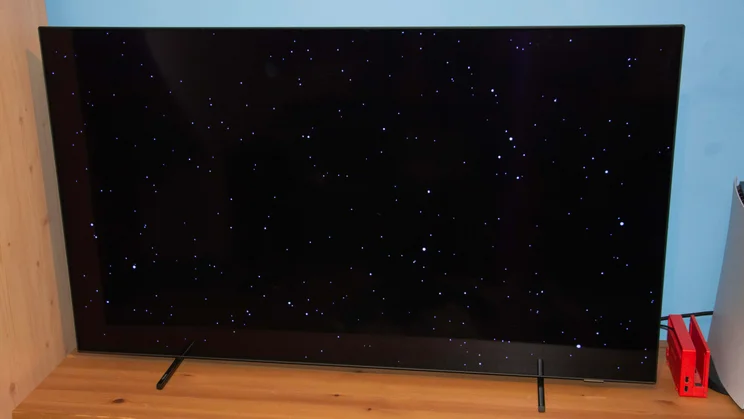 Front view of the Philips OLED760 TV displaying a night sky with stars