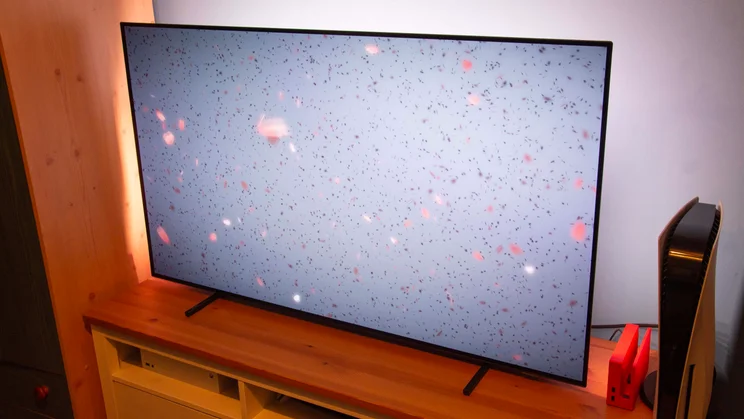 Right view of the Philips OLED760 TV displaying a grey background and confetti