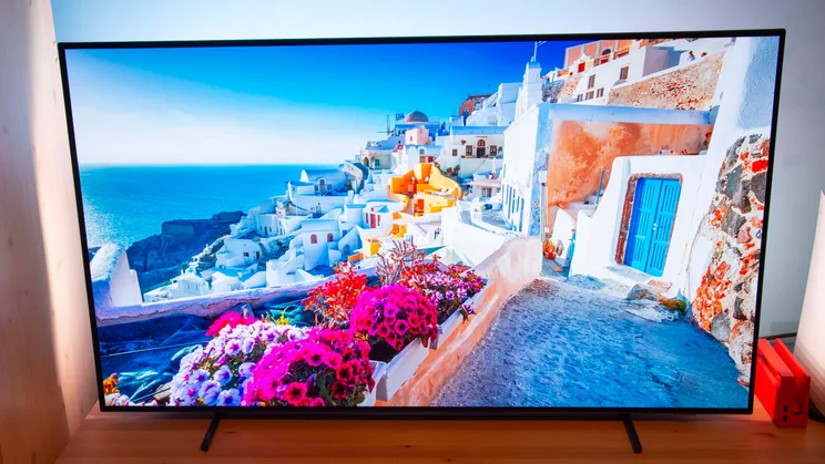 Front view of the Philips OLED760 TV displaying a coastal scene in Santorini