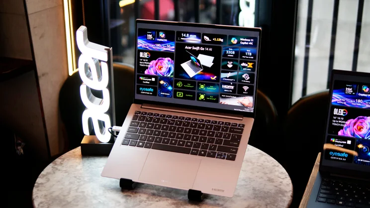 Acer Swift Go 14 (2026) on a laptop stand with a lit Acer logo to the side