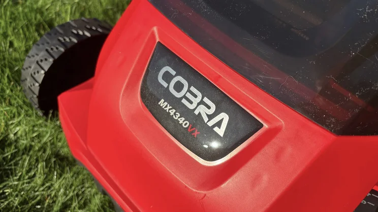 A closeup of the Cobra MX4340VX lawn mower's logo badge