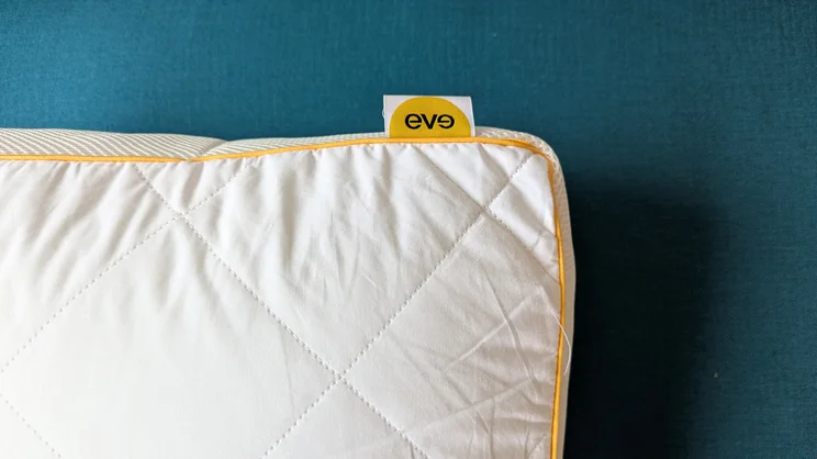 A birds-eye-view of a corner of the Eve Hybrid Side Sleeper pillow, and Eve label