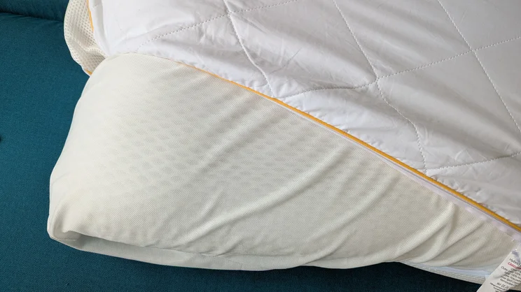The Eve Hybrid Side Sleeper pillow with cover partially removed