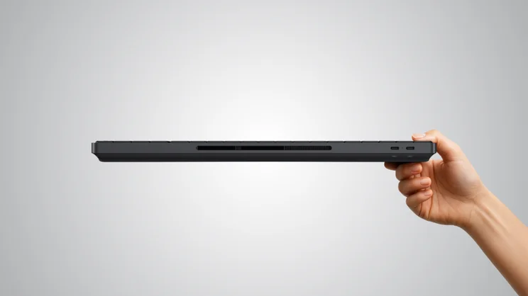 The HP EliteBoard G1a PC, pictured from the rear, being held in hand