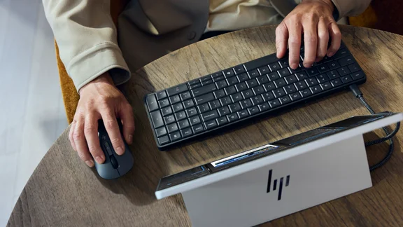 The HP EliteBoard G1a, pictured from above, connected to a portable monitor