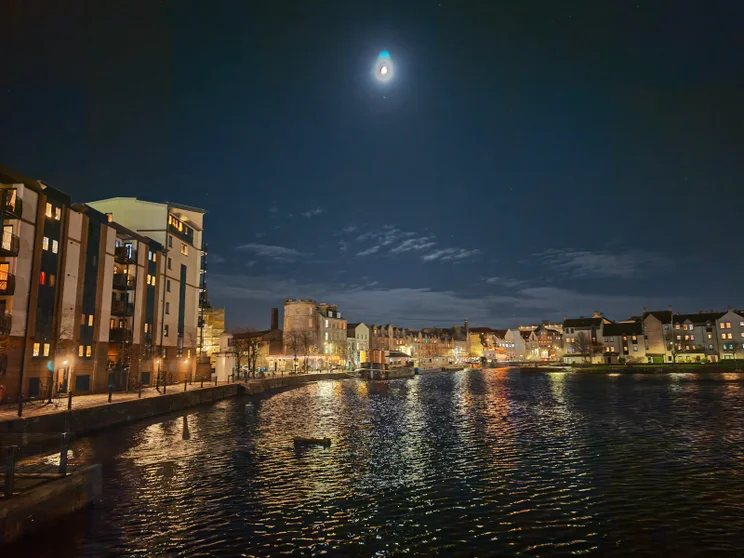 A river at night, lights reflected on the water