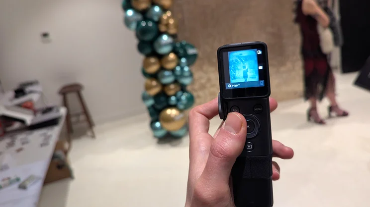 A POV of the Instax Mini Evo Cinema in use, using the controls to cycle through clips