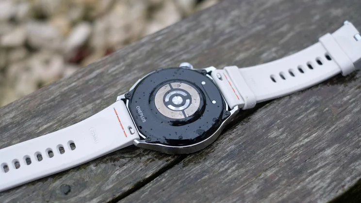 OnePlus Watch Lite on a wooden beam, face down