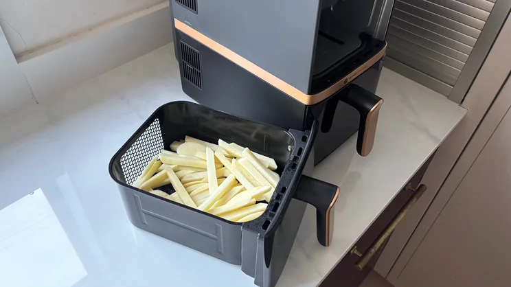Raw chips in a basket of the Philips 4000 Series Stacked Dual Basket Air Fryer