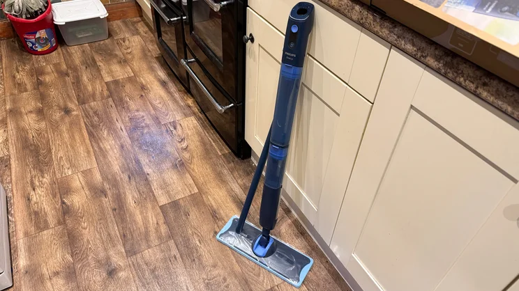 The Philips OneUp mop, unassembled and propped up against a kitchen counter