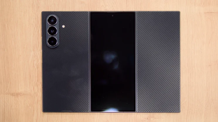 The Samsung Galaxy Z TriFold, unfolded, placed on a wood surface, pictured from the rear