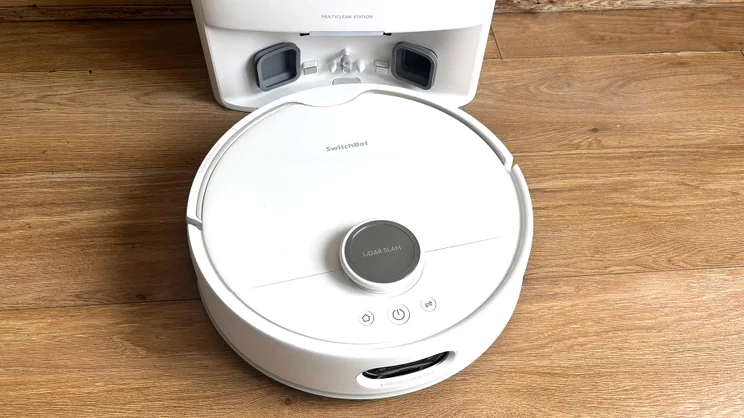 The Switchbot S20 robot vacuum, in front of its base, viewed from above