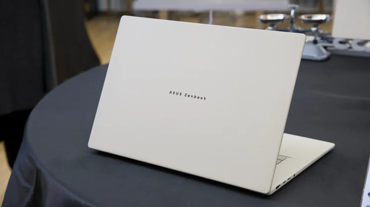 The Asus Zenbook A16 (2026), open, pictured from the rear left quarter