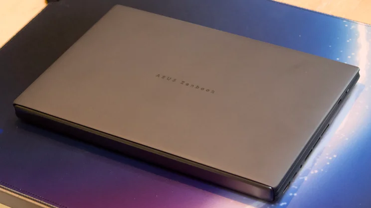 The Asus Zenbook Duo 2026, closed, photographed from above on a blue and purple mouse mat