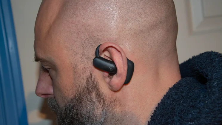The left Anker Soundcore AeroFit 2 Pro earbud being worn in ANC mode