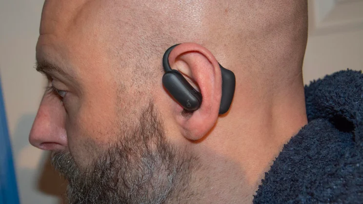 The left Anker Soundcore AeroFit 2 Pro earbud being worn in its open-ear awareness mode