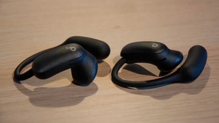 The Anker Soundcore AeroFit 2 Pro wireless open-fit earbuds on a wooden table