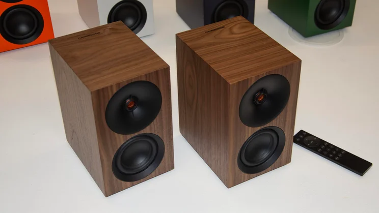 The Cambridge Audio L/R S active speakers in Real Walnut side by side on a white table