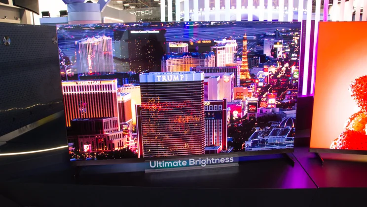 Front view of the 98in TCL X11L SQD Mini LED TV displaying a night time image of Trump International Hotel, Las Vegas