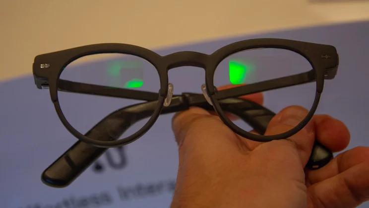 Front view of the XGIMI Memo One smart glasses being held in a person's hand