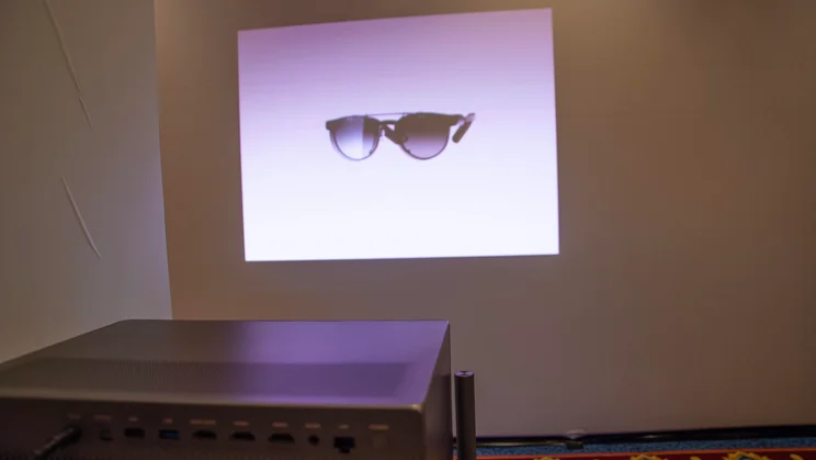 Rear view of the XGIMI Titan Noir Max projector beaming an image onto a white wall at CES in Las Vegas