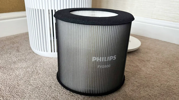 The Philips AC0920/10 air purifier's pre-filter, removed and placed on the floor