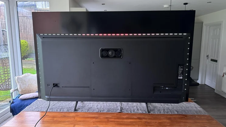 Rear view of the Philips OLED810 TV with its Ambilight on