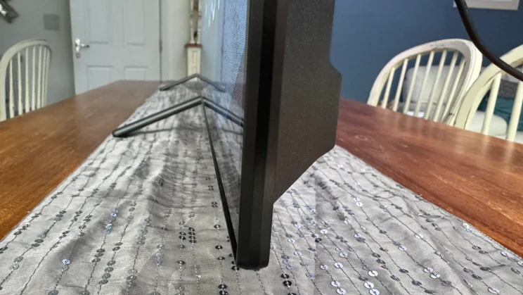 Side view of the Philips OLED810 TV on a table in an open-plan kitchen