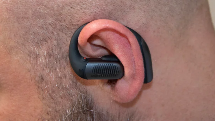 Close-up of the left earpiece of the Shokz OpenFit Pro being worn
