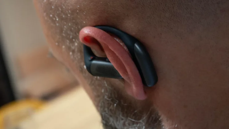 Rear view of the left earpiece of the Shokz OpenFit Pro being worn