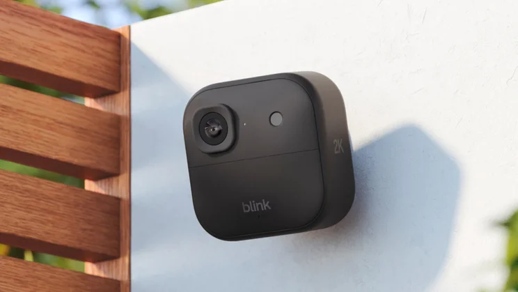 Blink Outdoor Camera 2K+ camera mounted on a white rendered wall
