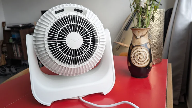 A back view of the Dreo Smart Whole Room Heater 714s on a red table in a living room