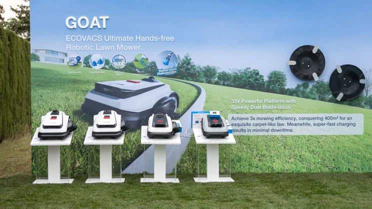 Ecovacs' range of GOAT robot lawn mowers on display on a lawn