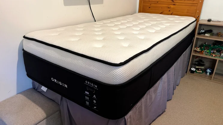 The Origin LumbarCloud mattress on a bedframe in a bedroom