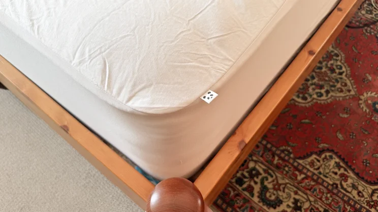A closeup of the corner of the Panda Bamboo mattress protector, on a mattress