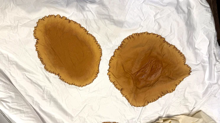 A closeup of two coffee stains on the Panda Bamboo mattress protector