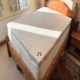 The Panda Hybrid Bamboo Mattress topper on a bed in a well-lit bedroom