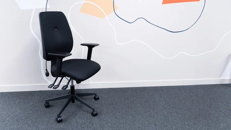 The Posturite Homeworker Plus office chair in an office, against a wall