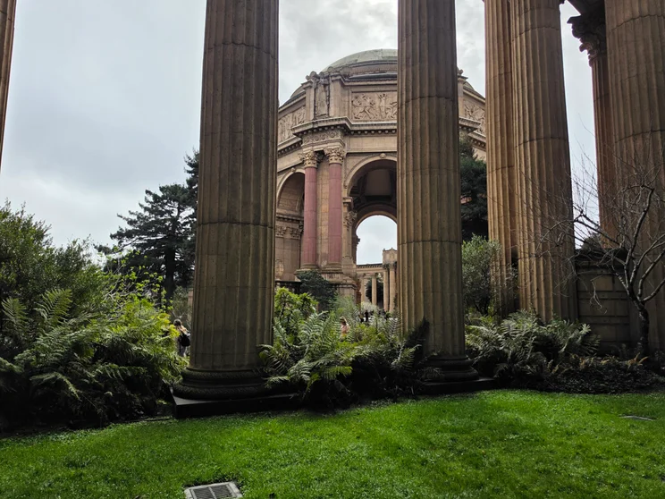 A stone structure viewed from behind pillars