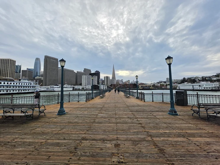 A long jetty, city in the background