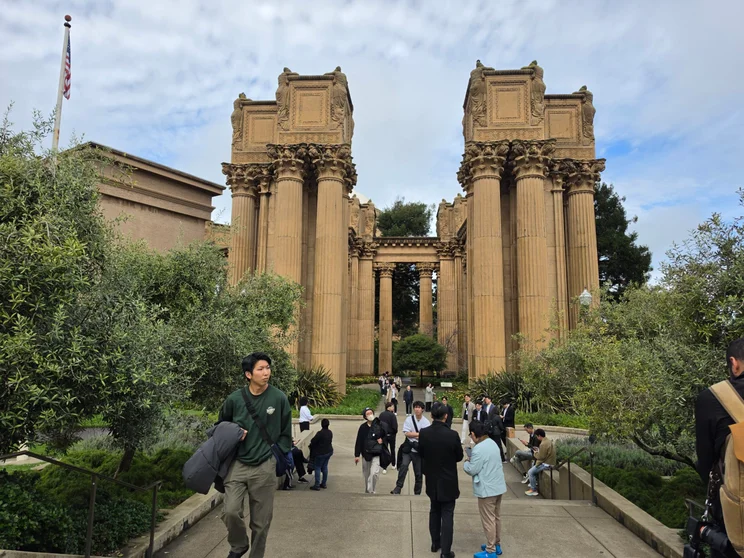 Stone building with people milling about in the foreground