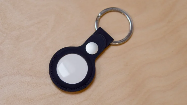 The Apple AirTag (2nd gen) pictured in a blue leather key fob