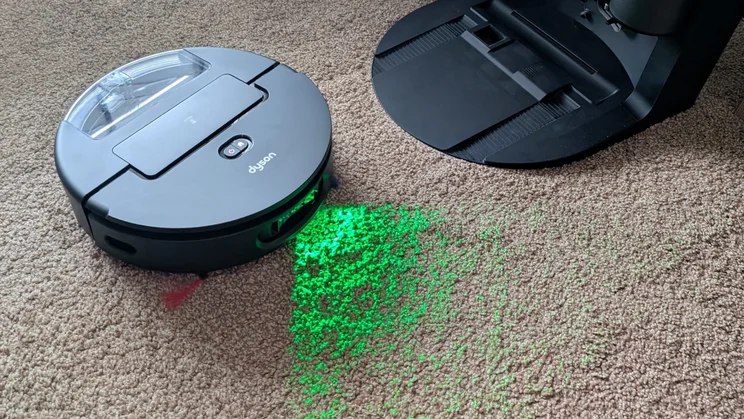 The Dyson Spot and Scrub pictured vacuuming a brown carpet
